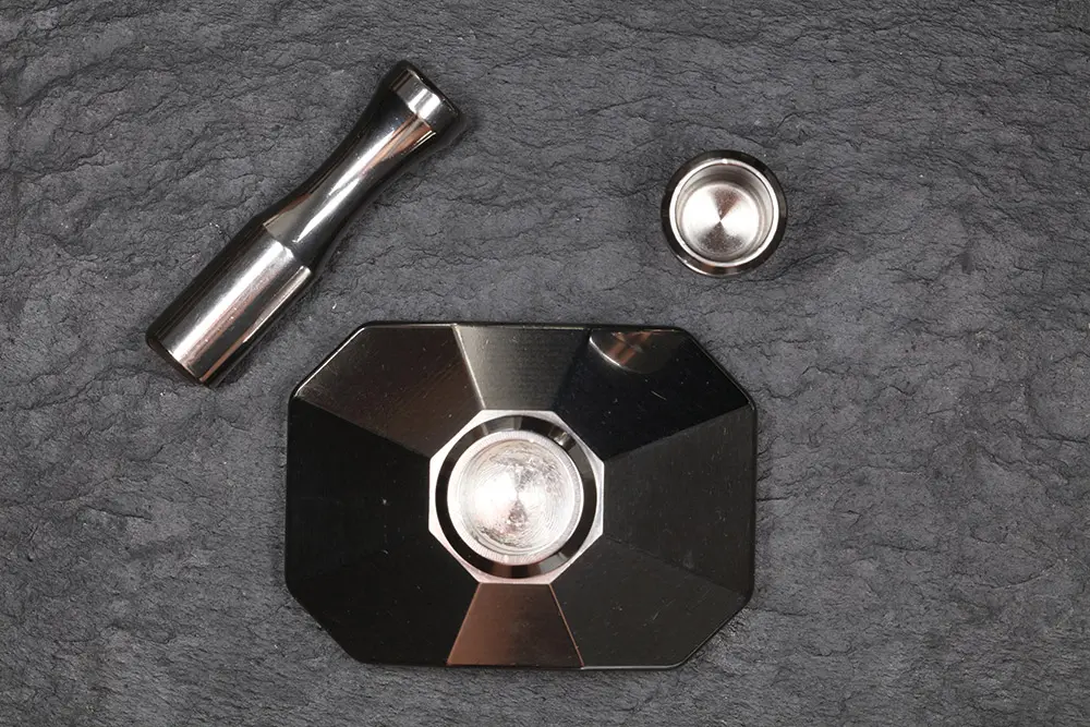 Top view: the pestle and the cup laid above the open base