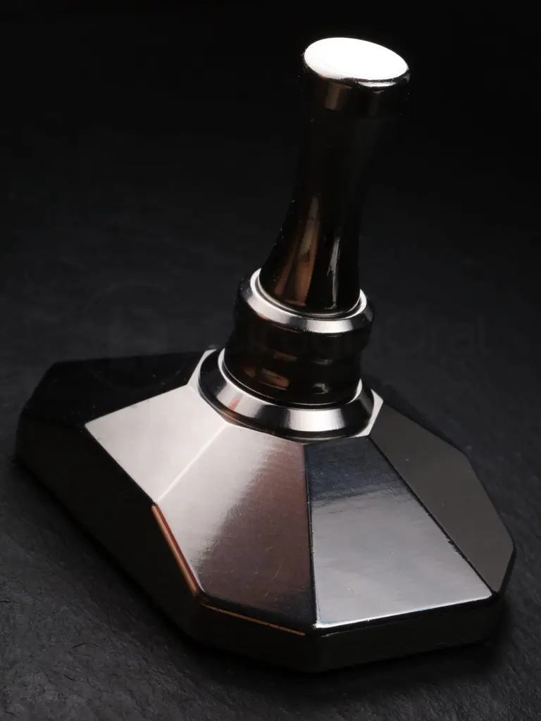 The Bone Crusher assembled and standing on dark slate, its polished facets catching the light